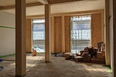 Behind it, the new wooden building is being built.
