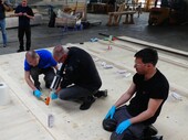 Employees of TS3 and Timbatec glue the working platform