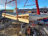 The spectacular folding/angled roof is lifted into place.